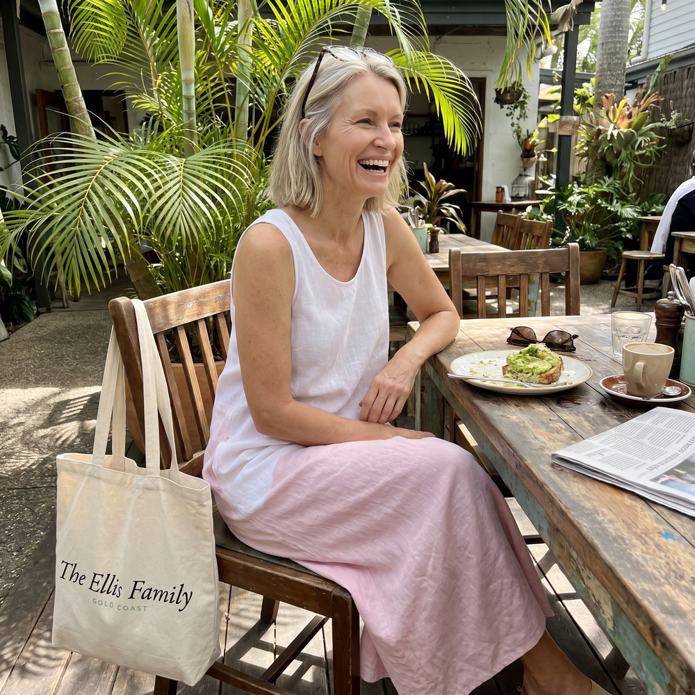 Woman in a Byron Bay cafe courtyard in a white and pink midi dress