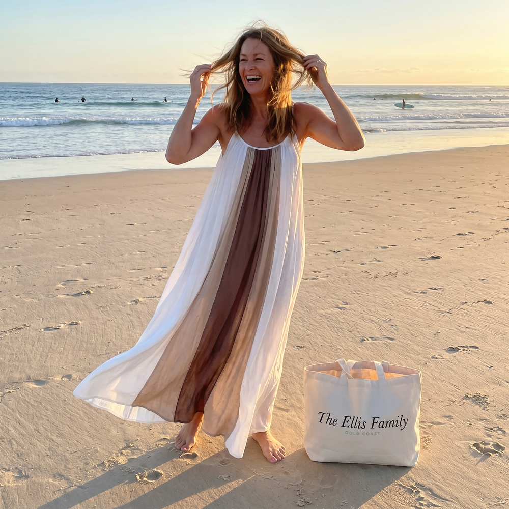 Woman at Kirra Beach at golden hour in a flowing maxi dress