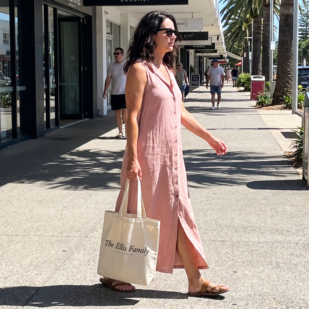 Woman crossing the Broadbeach esplanade in a pink open front button maxi dress